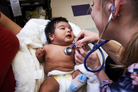 Doctor taking women's blood pressure